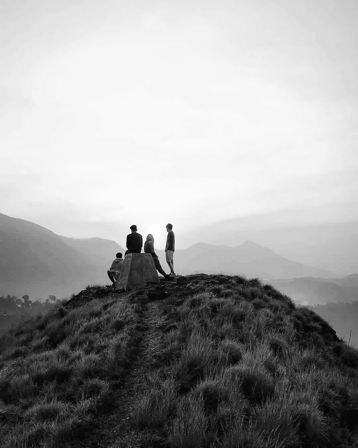 Friends standing together on a misty hilltop